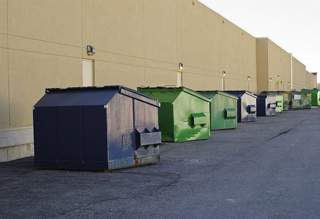 a row of blue construction dumpsters on a job site in Lenore ID